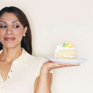 Woman Tempted by Slice of Cake